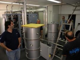 Technicians in the transmission room installing the liquid-cooler system for the digital transmitters.
